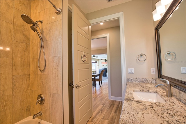 35 Medalist Rd, Rotonda West, FL 33947 - bathroom with wood finished floors, shower / tub combination, and vanity