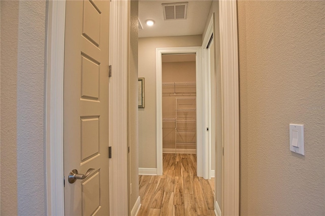 35 Medalist Rd, Rotonda West, FL 33947 - hallway featuring light wood-style flooring and a textured wall