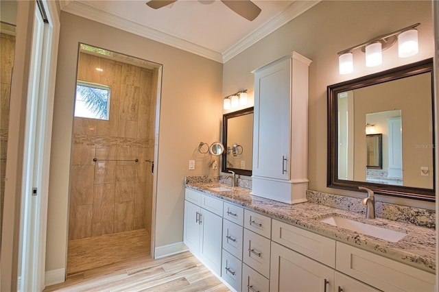 35 Medalist Rd, Rotonda West, FL 33947 - bathroom featuring double vanity, walk in shower, ceiling fan, crown molding, and wood finished floors