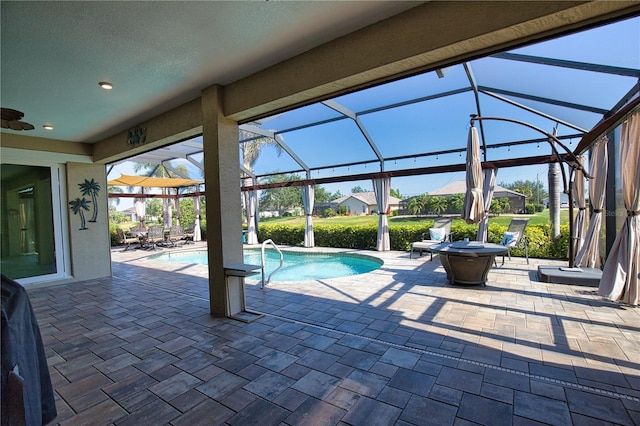 35 Medalist Rd, Rotonda West, FL 33947 - outdoor pool featuring a patio area, glass enclosure, and a ceiling fan