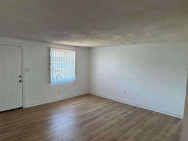 194 Garden Ave NW, Port Charlotte, FL 33952 - interior space featuring baseboards, wood finished floors, and a textured ceiling