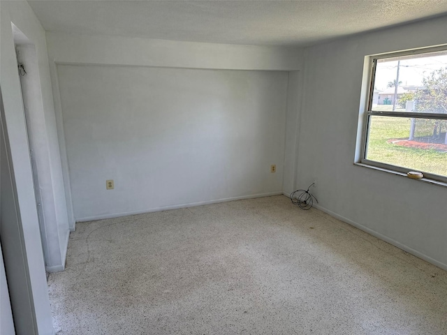 194 Garden Ave NW, Port Charlotte, FL 33952 - spare room featuring baseboards, a textured ceiling, and speckled floor
