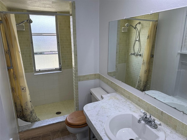 194 Garden Ave NW, Port Charlotte, FL 33952 - bathroom with a shower stall, a healthy amount of sunlight, toilet, and a sink