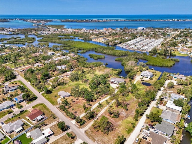 birds eye view of property featuring a water view and a residential view