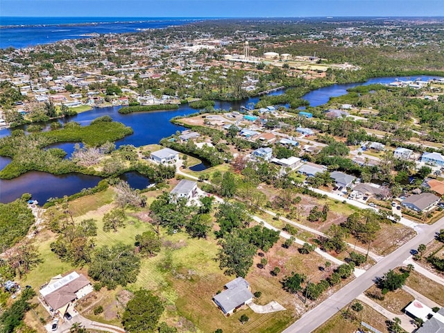 birds eye view of property featuring a water view and a residential view
