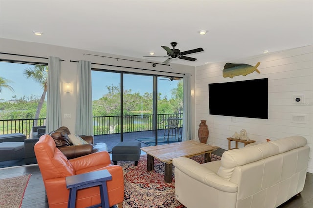 living area with a ceiling fan, recessed lighting, and wood finished floors