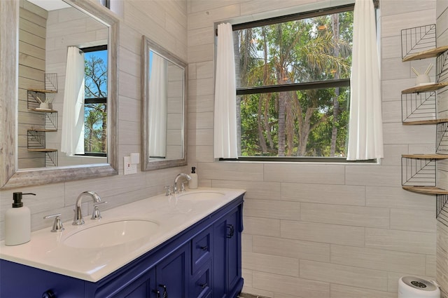 bathroom with double vanity, a sink, and decorative backsplash