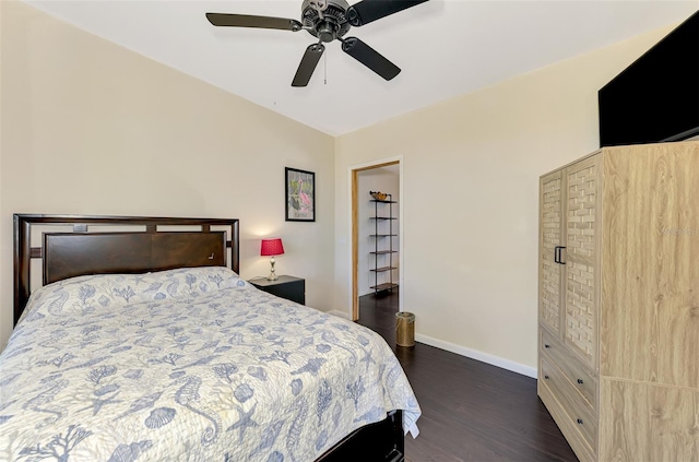 bedroom with baseboards, a ceiling fan, and dark wood finished floors