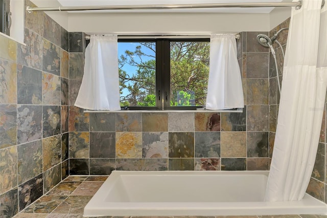 full bathroom featuring a bath and tiled shower