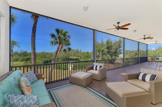 sunroom with ceiling fan and outdoor lounge area