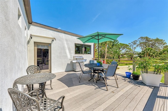 wooden terrace with outdoor dining area