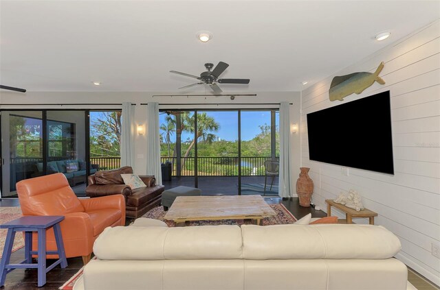 living room with recessed lighting, ceiling fan, wood finished floors, and a wealth of natural light