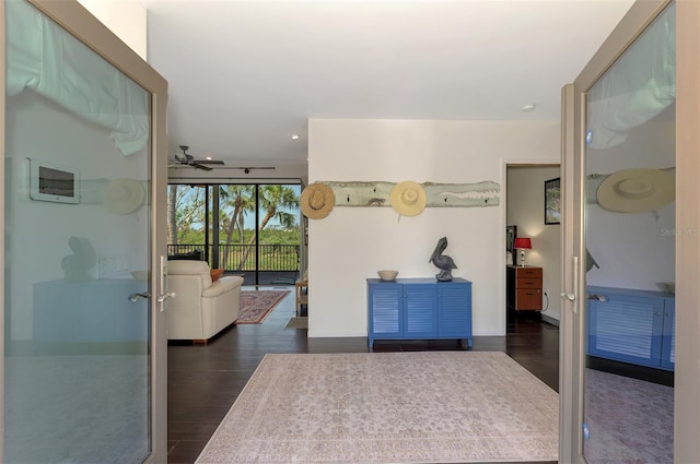hallway featuring recessed lighting, baseboards, and dark wood-type flooring