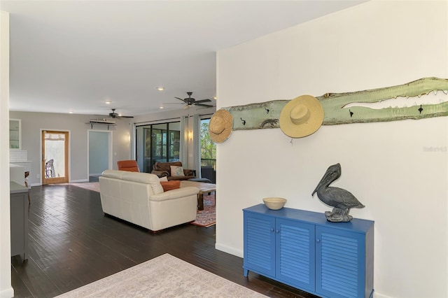 living area featuring baseboards, dark wood-style flooring, a ceiling fan, and recessed lighting