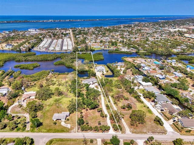 drone / aerial view with a residential view and a water view