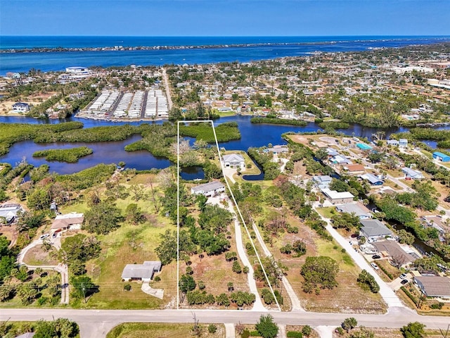 drone / aerial view with a residential view and a water view