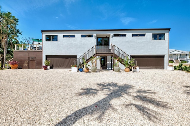 view of front of house featuring stairs and stucco siding