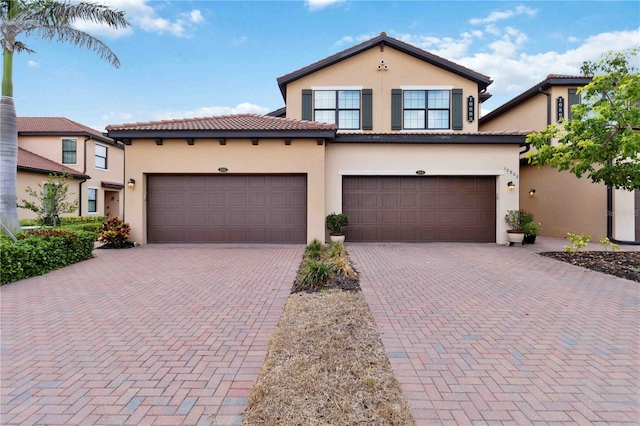 10805 Tarflower Dr Unit 101, Venice, FL 34293 - mediterranean / spanish-style home with stucco siding, decorative driveway, and a tile roof
