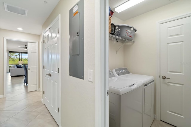 10805 Tarflower Dr Unit 101, Venice, FL 34293 - clothes washing area with washing machine and clothes dryer, light tile patterned floors, electric panel, and recessed lighting
