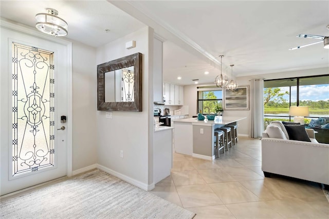 10805 Tarflower Dr Unit 101, Venice, FL 34293 - entrance foyer featuring a chandelier, light tile patterned flooring, baseboards, and recessed lighting
