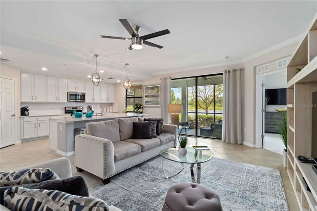 10805 Tarflower Dr Unit 101, Venice, FL 34293 - living area featuring light tile patterned flooring, ornamental molding, a ceiling fan, recessed lighting, and a chandelier