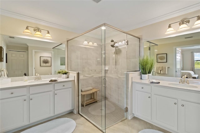 10805 Tarflower Dr Unit 101, Venice, FL 34293 - ensuite bathroom featuring ornamental molding, a stall shower, two vanities, and tile patterned flooring