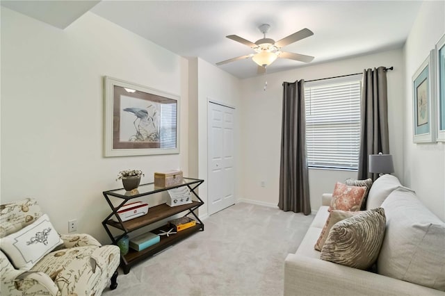 10805 Tarflower Dr Unit 101, Venice, FL 34293 - living area featuring a ceiling fan, light carpet, and baseboards
