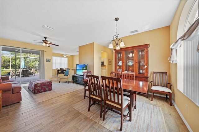 4004 Landor Ct, Venice, FL 34293 - dining space with baseboards, ceiling fan with notable chandelier, visible vents, and light wood-type flooring