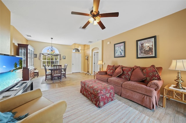 4004 Landor Ct, Venice, FL 34293 - living room with light wood finished floors, baseboards, arched walkways, and ceiling fan with notable chandelier