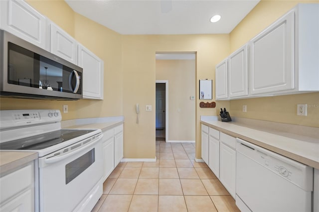 4004 Landor Ct, Venice, FL 34293 - kitchen featuring white appliances, light tile patterned floors, light countertops, white cabinets, and recessed lighting