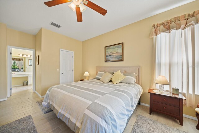 4004 Landor Ct, Venice, FL 34293 - bedroom with wood finished floors, visible vents, baseboards, and ensuite bathroom