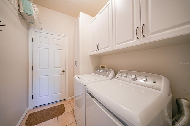 4004 Landor Ct, Venice, FL 34293 - laundry room with washing machine and dryer, baseboards, cabinet space, and light tile patterned flooring