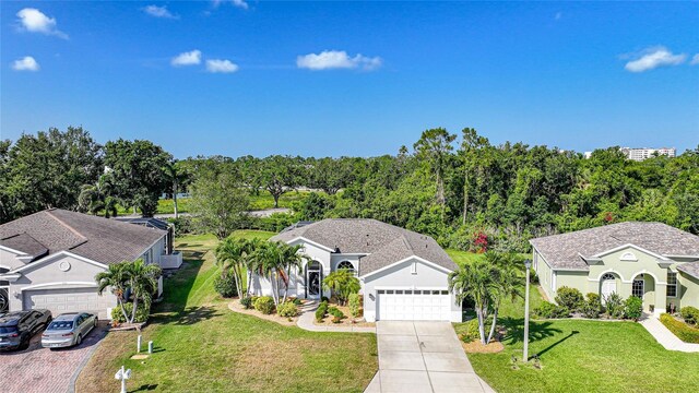 4004 Landor Ct, Venice, FL 34293 - view of front facade featuring an attached garage, a front lawn, and concrete driveway