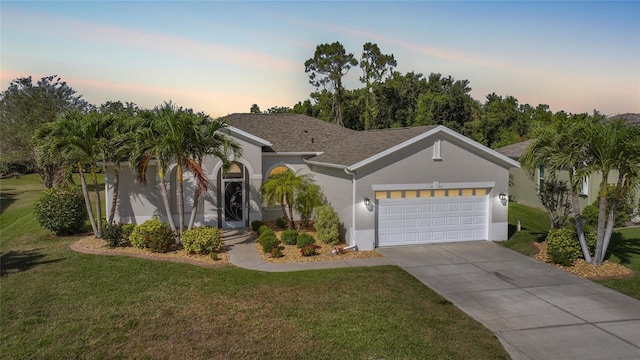 4004 Landor Ct, Venice, FL 34293 - view of front facade with stucco siding, a lawn, driveway, and a garage