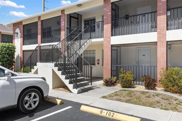 1531 Placida Rd Unit 201, Englewood, FL 34223 - view of building exterior featuring uncovered parking and stairs