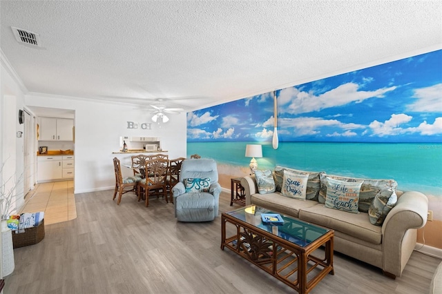 1531 Placida Rd Unit 201, Englewood, FL 34223 - living room with a ceiling fan, a textured ceiling, visible vents, and light wood-style floors