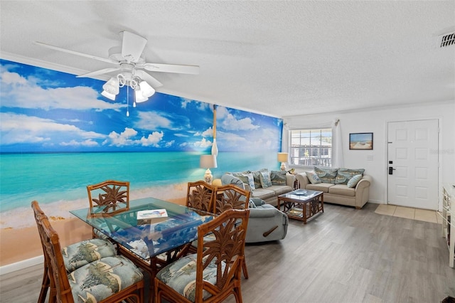 1531 Placida Rd Unit 201, Englewood, FL 34223 - dining room with baseboards, a textured ceiling, light wood finished floors, and a water view