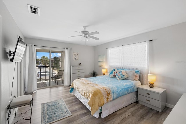 1531 Placida Rd Unit 201, Englewood, FL 34223 - bedroom with baseboards, visible vents, a ceiling fan, wood finished floors, and access to outside