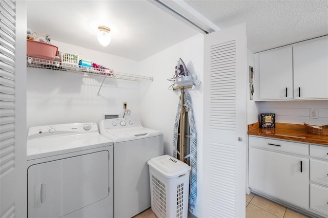 1531 Placida Rd Unit 201, Englewood, FL 34223 - laundry room featuring washing machine and clothes dryer, a textured ceiling, laundry area, and light tile patterned floors