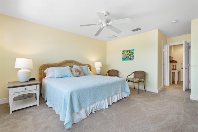 bedroom with light carpet, visible vents, and baseboards