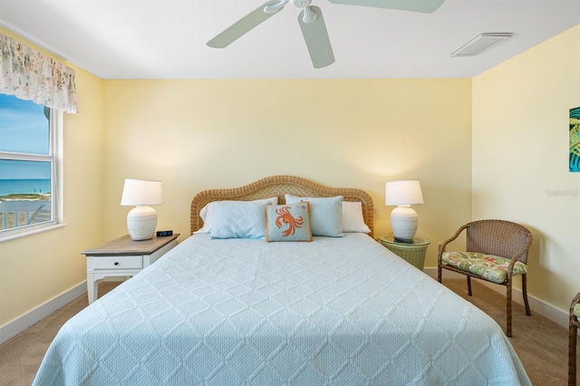 bedroom with baseboards, a ceiling fan, visible vents, and carpet floors