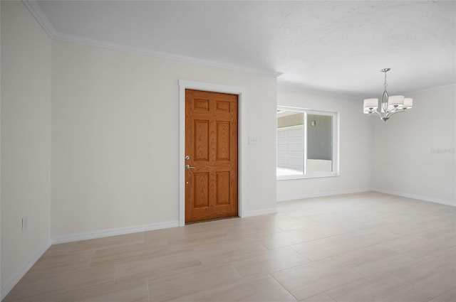 spare room with crown molding, an inviting chandelier, and baseboards