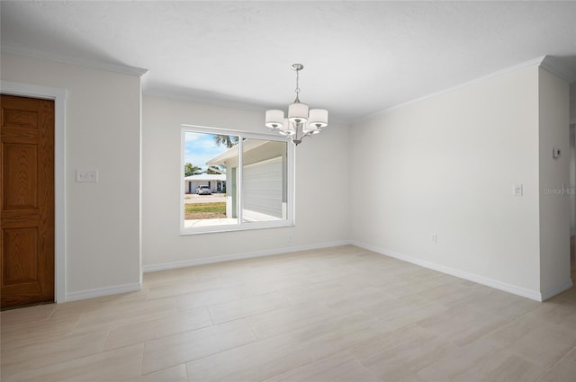 spare room with a chandelier, crown molding, and baseboards