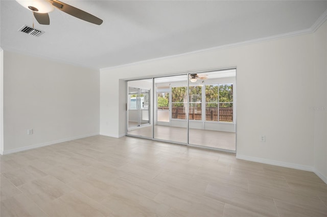 unfurnished room featuring ornamental molding, a ceiling fan, visible vents, and baseboards