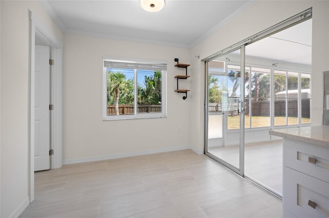 doorway featuring baseboards and crown molding