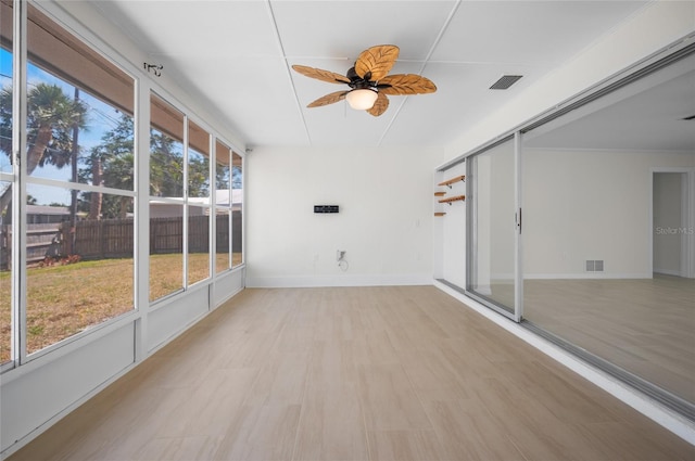 unfurnished sunroom with ceiling fan and visible vents