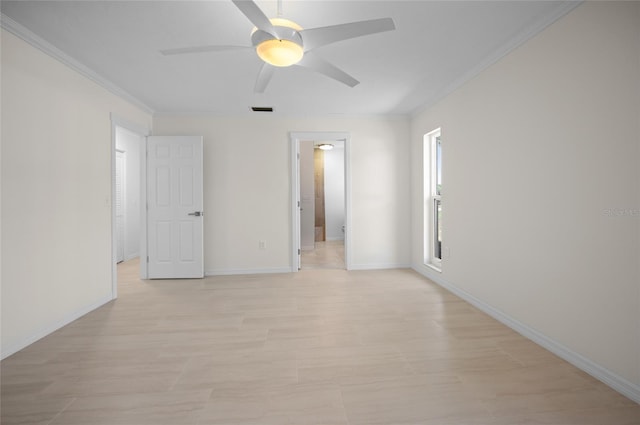 unfurnished bedroom with baseboards, visible vents, ornamental molding, and ceiling fan