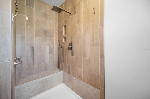 full bath featuring a tile shower