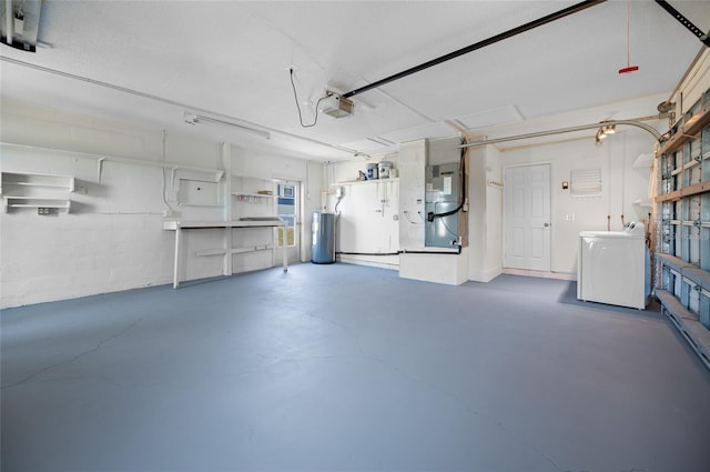 garage with a garage door opener, gas water heater, washer and dryer, and heating unit