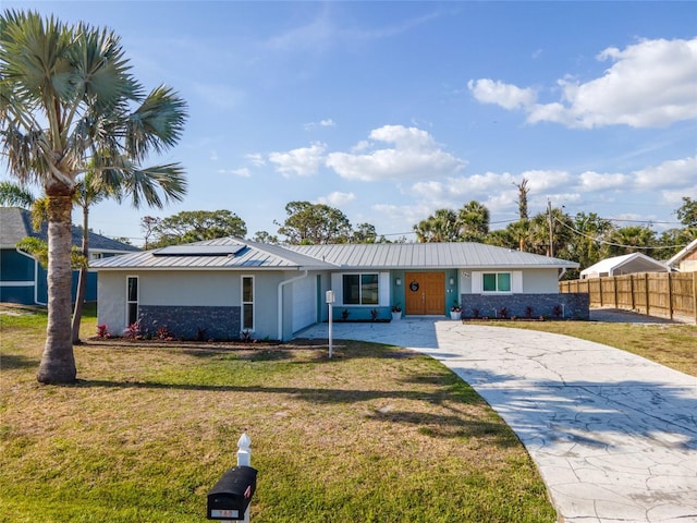 ranch-style home with a front yard, stucco siding, concrete driveway, and fence